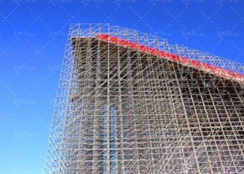 High-rise construction of scaffolding against a blue sky