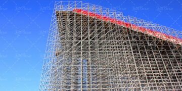 High-rise construction of scaffolding against a blue sky