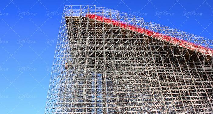 High-rise construction of scaffolding against a blue sky