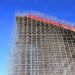 High-rise construction of scaffolding against a blue sky