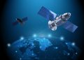 Two satellites with large solar arrays orbit a glowing blue Earth, illustrating space technology and communication links.
