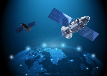 Two satellites with large solar arrays orbit a glowing blue Earth, illustrating space technology and communication links.