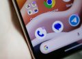 Close-up of a smartphone home screen with app icons, including Google and Chrome, on a curved display edge.