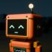Orange retro-style toy robot with a glowing face and antenna, standing in a dim outdoor scene at night.