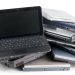 6 روش بسیار ساده برای استفاده مجدد از لپ تاپ خراب قدیمی 8 Pile of assorted laptops stacked in a heap, showing keyboards and side ports.
