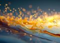 تولید هیدروژن از آب با نور؛ محققان ماده جدیدی را ایجاد کرده اند 18 Golden liquid splashes across a blue surface with glowing droplets and a warm sunset glow in the background.