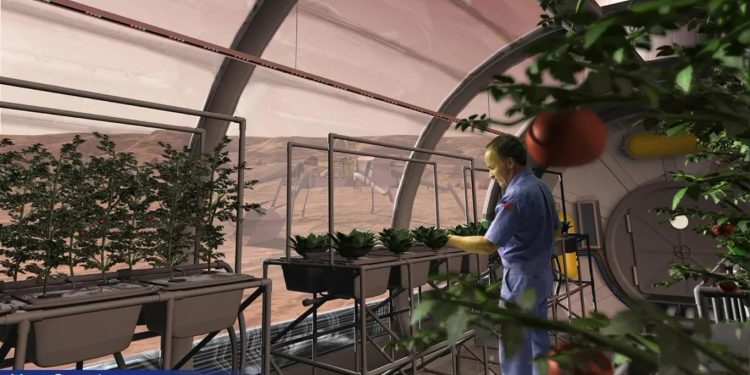 Inside a Mars greenhouse, a worker in blue coveralls tends row after row of leafy plants in raised troughs along a curved dome with a red Martian landscape visible outside