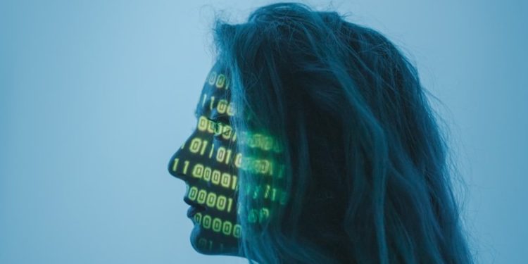 OpenAI به دلیل نقش احتمالی ChatGPT در مرگ یک مرد جوان شکایت کرد 1 تصویری پروفایلی و استودیویی از نیمرخ یک زن با موهای آبیرنگ که کدهای باینری سبزونورانی روی صورت و بدنی او بازتاب یافته و پروژکتور شده است