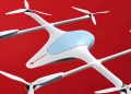 Quadcopter delivery drone in white with four propellers, blue cockpit window, and a Doordash logo on the fuselage against a red background.