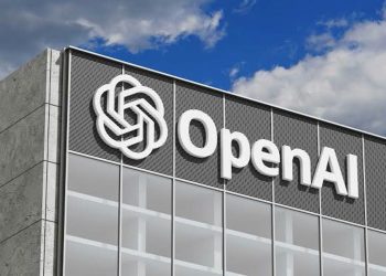 Exterior of a modern office building with a large OpenAI sign and logo on the facade.