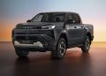 تماشا کنید: تویوتا هایلوکس برقی از سقوط یک کاروان 760 کیلوگرمی جان سالم به در می برد 17 Dark gray Toyota Hilux BEV pickup shown in a studio with a warm sunset gradient background, angled front-left view