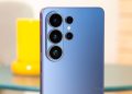 Blue smartphone rear with four camera lenses arranged in a vertical cluster and a small flash.