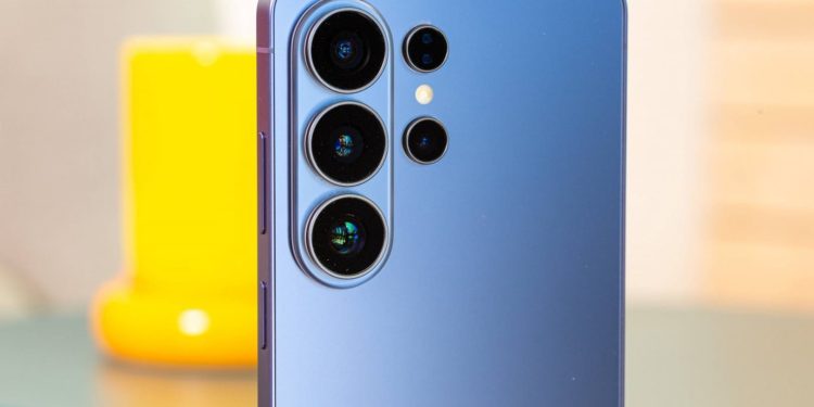 سامسونگ و گوگل قیمت گوشی های ارزان قیمت خود را افزایش می دهند 1 Blue smartphone rear with four camera lenses arranged in a vertical cluster and a small flash.