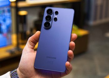 Purple Samsung Galaxy phone held in a hand, showing its quad rear camera module.