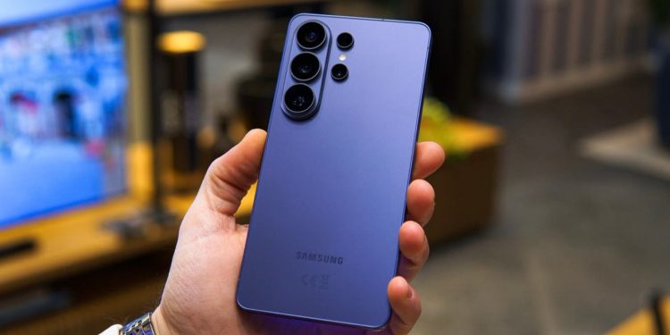 Purple Samsung Galaxy phone held in a hand, showing its quad rear camera module.