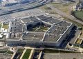 Aerial view of the Pentagon complex in Arlington, Virginia, showing its five-sided building and surrounding roads and parking lots.
