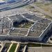 Aerial view of the Pentagon complex in Arlington, Virginia, showing its five-sided building and surrounding roads and parking lots.